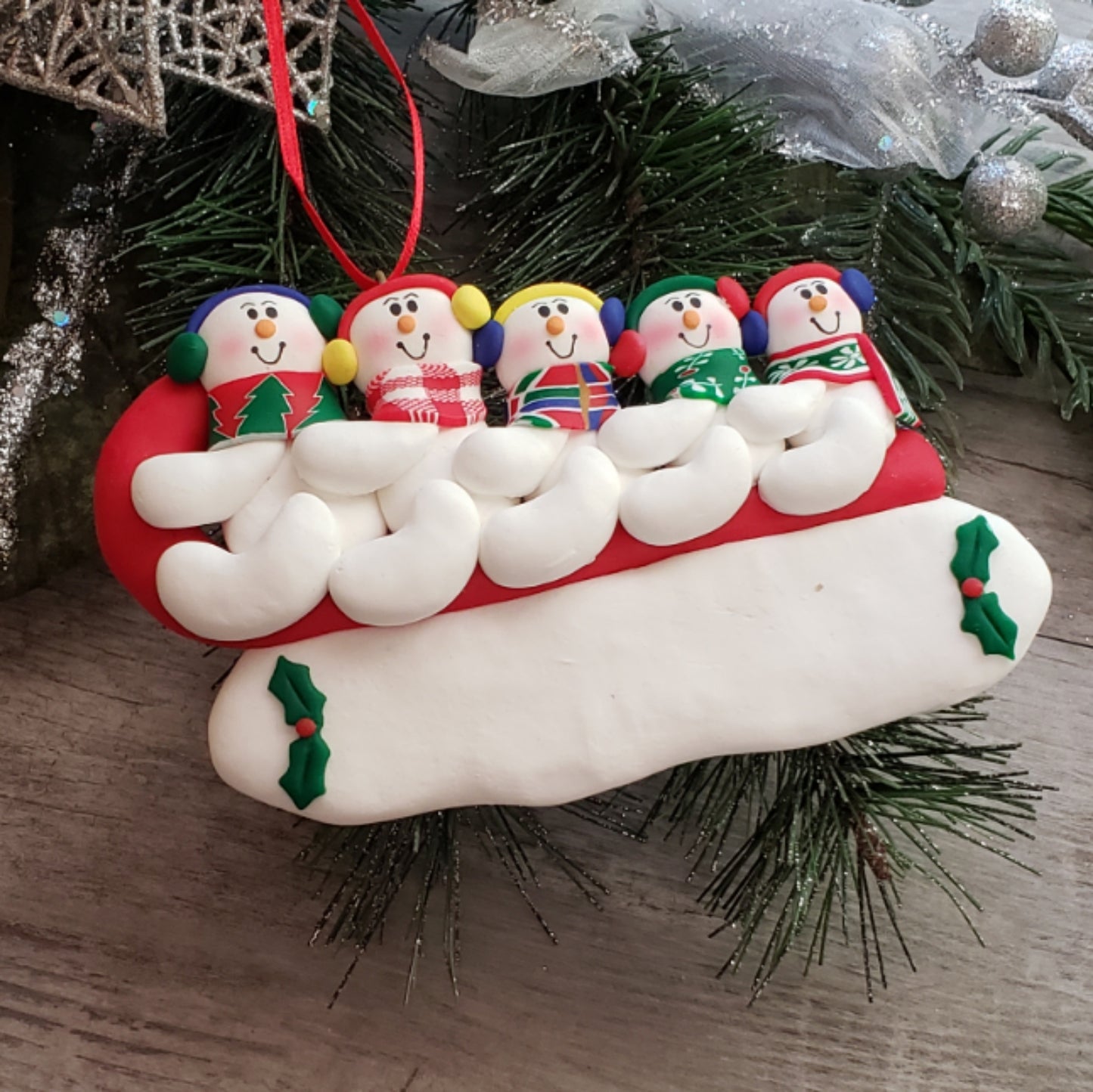 Sledding Snowman Family