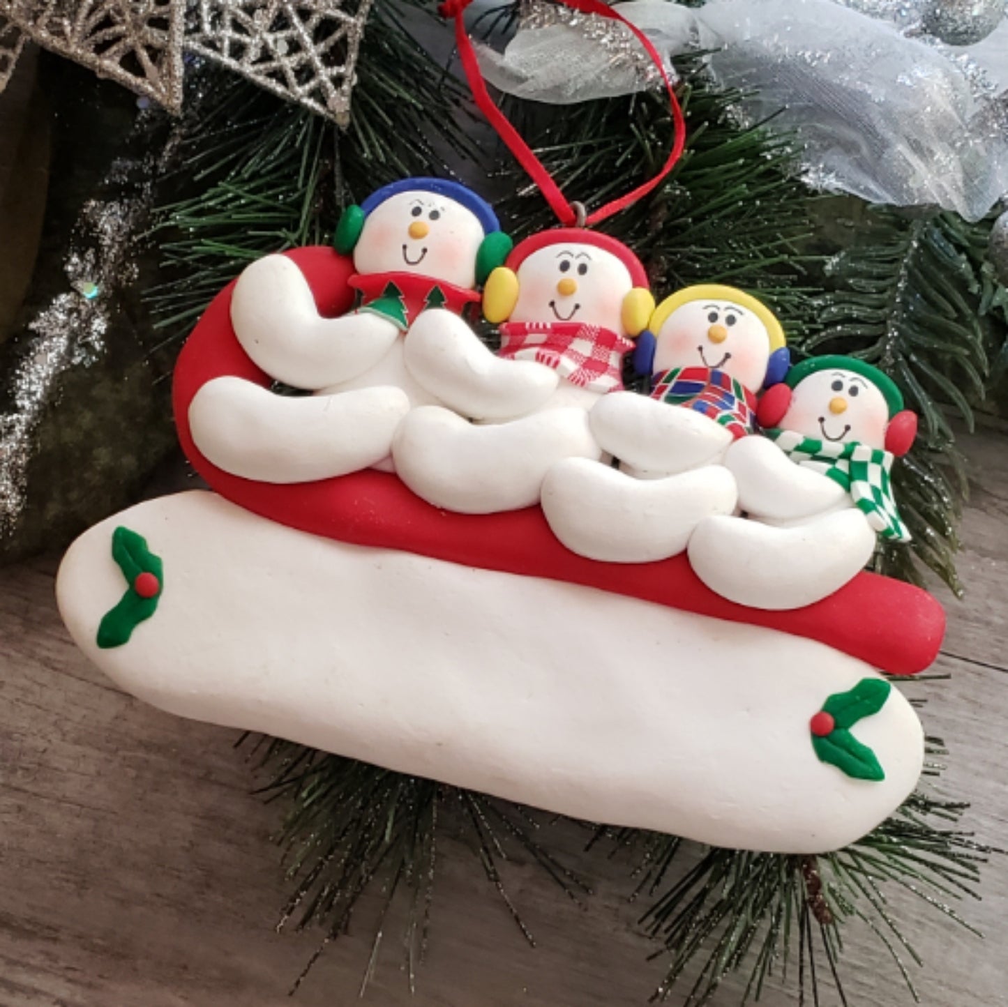 Sledding Snowman Family