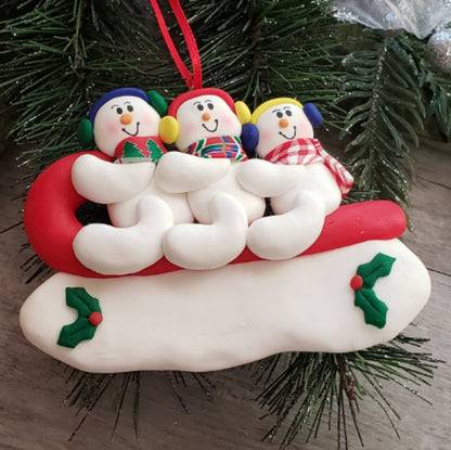 Sledding Snowman Family